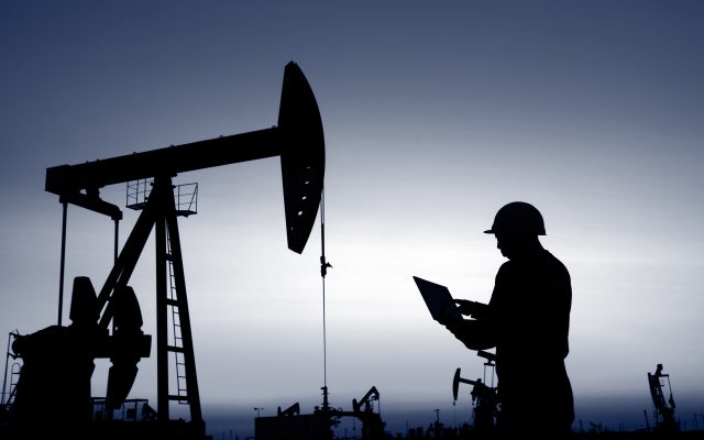 Workers on tablet in Oil field